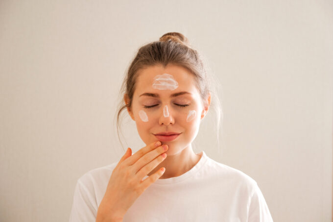 young girl takes care of her face skin.